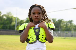 Young person wearing LEGION M-80 Youth Highlight Football Shoulder Pads