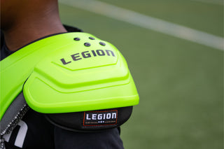 Legion shoulder pads in neon green with black Legion logo
