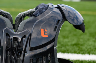 LEGION M-250 Varsity Football Shoulder Pads on a green field with a white line