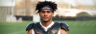 Football player wearing a black Legion headband and black shoulder pads